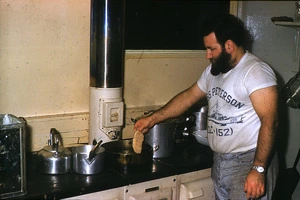 Bob Rae preparing crumbed pork cutlets, Campbell Island