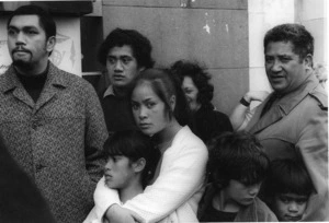 Family watching Vietnam War soldiers marching