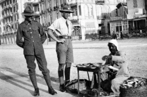World War I soldiers next to a man selling roasted corn, Alexandria, Egypt