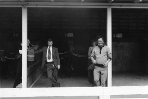 Group standing in stable boxes at Ellerslie Race Course, Auckland