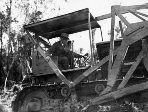 Robert Semple, then Minister of Works, on a Caterpillar diesel bulldozer