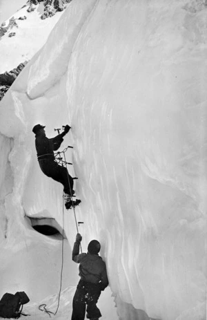 Man climbing up an ice cliff on Mount Rolleston, Westland