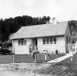 The Holmes family outside their home in Naenae