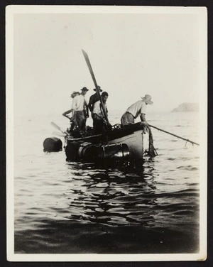 Four men standing in a boat