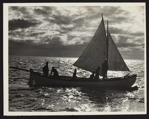 Boat in the ocean at sunset facing lengthways