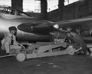 Bomb being loaded into a De Havilland Vampire plane