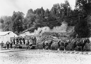 Men aboard a horse drawn logging railway wagon