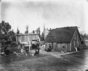 Unidentified group of people in front of a whare, Nelson