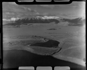 Lake Alexandrina (front), Lake Mcgregor (middle), and Lake Tekapo (back), Mackenzie District, Canterbury Region, including Motuariki Island, small unidentified settlement, and light striking Mount Dobson