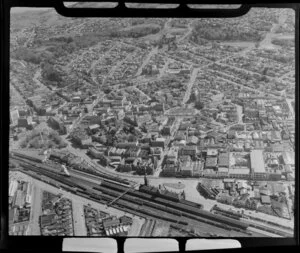 View showing Dunedin City Centre with Railway Station, Octagon with Saint Paul's Anglican Cathedral, Princess Street and Moray Place, residential and commercial buildings, and Prospect Park beyond