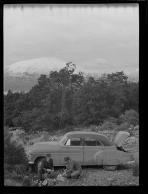 Harry Wigley and Keith [?] having a picnic beside the Chevrolet sedan, Lake Ohau, Waitaki County