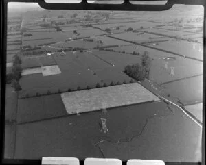 Leamington, Waikato District, view of farmland showing fields with hedgerows, close-up of mown field and power-line pylons