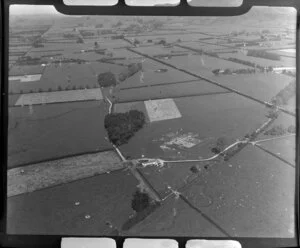 Leamington, Waikato District, view of farmland showing fields with hedgerows and power line pylons, mown field with barn