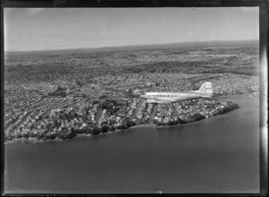 New Zealand National Airways Corporation (NAC) Flagship Dakota aircraft in flight over Auckland