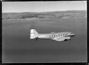 New Zealand National Airways Corporation (NAC) Flagship Dakota aircraft in flight over Auckland