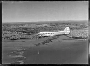 New Zealand National Airways Corporation (NAC) Flagship Dakota aircraft in flight over Auckland