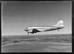 New Zealand National Airways Corporation (NAC) Flagship Dakota aircraft in flight over Auckland