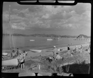 Beach scene including bathers and boats at Paihia, Bay of Islands