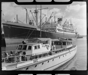 Auckland city waterfront, showing the ship Athenic and an unidentified boat