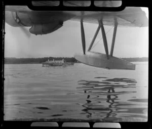 Men on boat as they leave the TEAL (Tasman Empire Airways Limited) ZK-AMM flying boat at Satupuala Base, Samoa