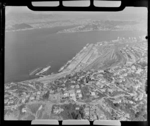 Wellington, with Wadestown in foreground and ships moored at wharves at Aotea Quay