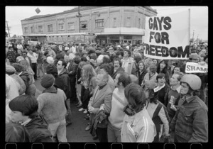 Large group of protesters, some with "Gays for Freedom" banner