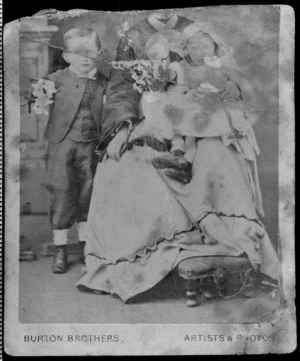 Studio portrait of unidentified woman and two children