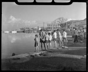 Papeete waterfront, Tahiti, showing local men and boys fishing