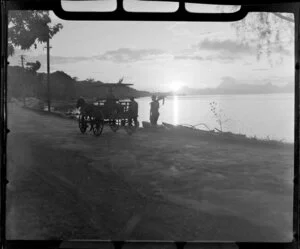 Papeete waterfront, Tahiti, showing sunset, horse drawn cart and men who have finished fishing