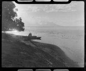 Papeete at sunset, Tahiti, showing two men ready to head out on their boats to fish