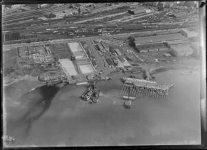 Stacked timber and car ferry, wharf for exports, Auckland