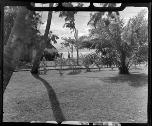 Tropique Hotel, Tahiti, shows an unidentified couple walking around the grounds surrounded by trees