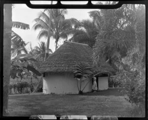 Royal Tahitian Hotel, Tahiti, showing woman outside hut and palm trees