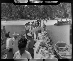 Akaiami, Aitutaki, Cook Islands, showing tourists probably heading to board the TEAL (Tasman Empire Airways Limited) Flying boat