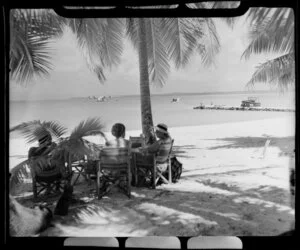 Island of Akaiami, Aitutaki Atoll, Cook Islands, shows tourists on the beach and a TEAL (Tasman Empire Airways Limited) Flying boat in the lagoon