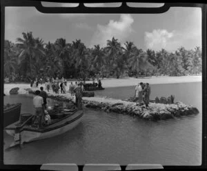 Crew and passengers prepare to be escorted to the TEAL (Tasman Empire Airways Limited) Flying boat, Akaiami, Aitutaki, Cook Islands