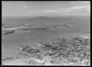 Waterfront scene, including cruise ship Orcades and other ships, Davonport and Rangitoto Island, Auckland
