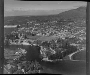 Taupo, showing houses and boats moored at shore and Mount Tauhara in the background