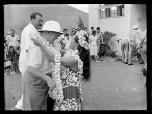 Welcoming reception for TEAL (Tasman Empire Airways Limited) passengers, visitors receiving flower necklace, Papeete, Tahiti