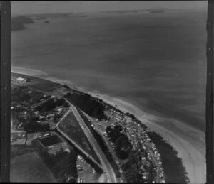 Orewa, Rodney County, Auckland, showing houses, roads and beach