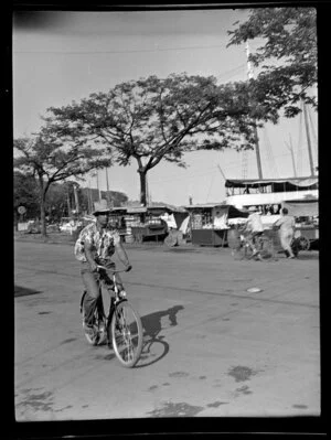 Street scene with man riding bicycle, Papeete, Tahiti