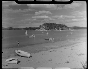 Beach scene at Paihia, Bay of Islands, showing bathers, boats and looking towards Taylor Island