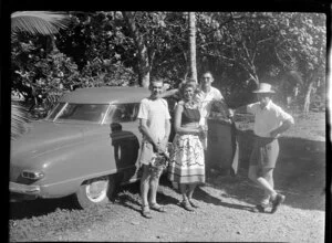 Visitors by a motor car, Tahiti