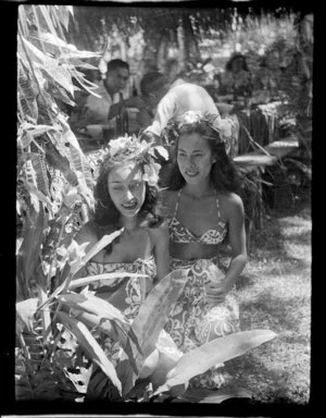 Welcoming reception in Tahiti showing guest dining and a young women next to plants