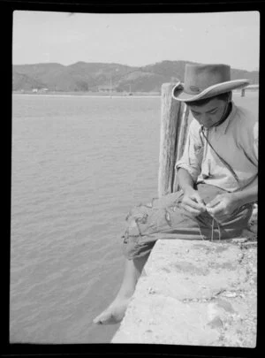 Henry Takimoana in a cowboy hat, line fishing off the wharf, Bay of Islands