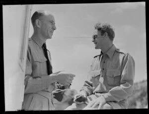 Captain N S Tom (left) and co-pilot J McCalder talking during the NAC (New Zealand National Airways Corporation) Bay of Islands scenic flight