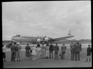 Canadian Pacific Airlines Inaugural DC 6B Service at Whenuapai, showing people watching aircraft departing