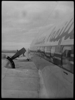 Canadian Pacific Airlines Inaugural DC 6B Service at Whenuapai, showing side view of aircraft