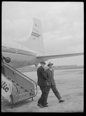 Canadian Pacific Airlines Inaugural DC 6B Service aircraft at Whenuapai airport, showing two unidentified men disembarking