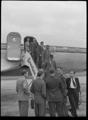 Canadian Pacific Airlines Inaugural DC 6B Service at Whenuapai, showing passengers disembarking aircraft